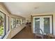 The exterior porch area features wood flooring and a seating area with a view at 8280 Ibis St, Sarasota, FL 34241