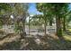 The property features an entrance framed by an arch, with a white fence surrounding the land at 8280 Ibis St, Sarasota, FL 34241