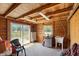 Functional storage room with wood paneling, sliding door, utility sink, and ample natural light at 8280 Ibis St, Sarasota, FL 34241