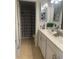 Bright bathroom with double vanity, decorative mirrors, and shower with stylish patterned curtain at 9011 Hammock Edge Pl, Bradenton, FL 34212