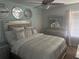 Well-lit bedroom with a large bed, mirrored accents, and comfortable furnishings at 9011 Hammock Edge Pl, Bradenton, FL 34212