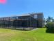 Exterior of the house from the backyard featuring the pool, patio, and lawn at 9011 Hammock Edge Pl, Bradenton, FL 34212