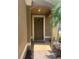 Charming home featuring a covered front door with textured stucco and brick paver walkway at 9011 Hammock Edge Pl, Bradenton, FL 34212