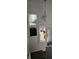 Hallway with staircase and modern hanging mirrors offering a unique design at 9011 Hammock Edge Pl, Bradenton, FL 34212