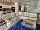 Bright living room features a large sectional couch, fluffy rug, and view of the entryway at 9011 Hammock Edge Pl, Bradenton, FL 34212