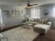 Bright living room with a cozy sectional, modern art, and abundant natural light at 9011 Hammock Edge Pl, Bradenton, FL 34212