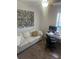 Bright office space featuring a comfortable sofa, a zebra painting and functional workspace at 9011 Hammock Edge Pl, Bradenton, FL 34212
