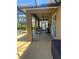 A covered patio with ceiling fans, lounge seating, and views of the pool at 9011 Hammock Edge Pl, Bradenton, FL 34212