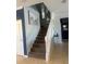 Bright foyer featuring a staircase with carpeted steps and contrasting dark blue accent wall at 9011 Hammock Edge Pl, Bradenton, FL 34212
