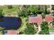 Aerial view of house on the lake showcasing lush greenery and surrounding homes at 9238 13Th Avenue Nw Cir, Bradenton, FL 34209