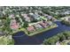 Aerial view of a home in a neighborhood with beautiful lake views and mature landscaping at 9238 13Th Avenue Nw Cir, Bradenton, FL 34209