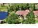 Aerial view of home with beautiful landscaping, well manicured lawn and lake view at 9238 13Th Avenue Nw Cir, Bradenton, FL 34209