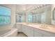 Bright bathroom featuring double sinks, beautiful lighting, jacuzzi tub and walk-in shower at 9238 13Th Avenue Nw Cir, Bradenton, FL 34209