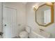 Bright bathroom boasts white walls, tile floors, a pedestal sink, and a gold-framed mirror at 9238 13Th Avenue Nw Cir, Bradenton, FL 34209