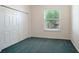 Simple bedroom featuring a large double door closet and an eye-pleasing view out of the window at 9238 13Th Avenue Nw Cir, Bradenton, FL 34209