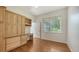 Office/bedroom with built-in cabinets, desk, hardwood flooring and a bright window at 9238 13Th Avenue Nw Cir, Bradenton, FL 34209
