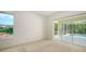 Relaxing bedroom featuring walkout to the pool and a peaceful view out the large window at 9238 13Th Avenue Nw Cir, Bradenton, FL 34209
