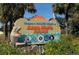 Welcome to Anna Maria Island community sign with a playful dolphin and manatee sculpture at 9238 13Th Avenue Nw Cir, Bradenton, FL 34209