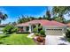 Well-maintained single Gathering home features lush landscaping, mature trees, and a brick walkway at 9238 13Th Avenue Nw Cir, Bradenton, FL 34209
