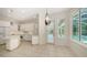 Bright white kitchen with marble counters, tiled floor and stainless appliances at 9238 13Th Avenue Nw Cir, Bradenton, FL 34209