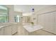 Bright white kitchen with marble counters, tiled floor and stainless appliances at 9238 13Th Avenue Nw Cir, Bradenton, FL 34209