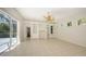 Living room with custom built-ins, ceiling fan and sliding glass doors at 9238 13Th Avenue Nw Cir, Bradenton, FL 34209