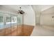 Bright living room boasts wood floors, ceiling fan, and sliding glass doors to a screened-in lanai at 9238 13Th Avenue Nw Cir, Bradenton, FL 34209