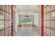 Open-concept living room with tile flooring, ceiling fan, and glass doors leading to the pool at 9238 13Th Avenue Nw Cir, Bradenton, FL 34209