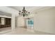 Bright living room boasts tile floors, white walls, a chandelier, and an open floor plan at 9238 13Th Avenue Nw Cir, Bradenton, FL 34209