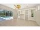 Living room with custom built-ins, ceiling fan and sliding glass doors to the pool at 9238 13Th Avenue Nw Cir, Bradenton, FL 34209