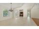 Bright living room boasts carpet, tile, white walls, a chandelier, and a double-door entrance at 9238 13Th Avenue Nw Cir, Bradenton, FL 34209