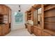 Well-lit office boasts custom built-ins, a desk, neutral carpet, and a window at 9238 13Th Avenue Nw Cir, Bradenton, FL 34209