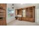 Well-lit office boasts custom built-ins, a desk, neutral carpet, and a window at 9238 13Th Avenue Nw Cir, Bradenton, FL 34209
