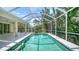 Screened-in pool with clear water and a view of lush tropical landscaping at 9238 13Th Avenue Nw Cir, Bradenton, FL 34209