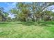 An expansive backyard with mature trees, perfect for outdoor activities and enjoying nature's beauty at 8711 Palmer Park Cir, Sarasota, FL 34238