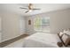 Well-lit bedroom with a ceiling fan, a bright window view, and neutral paint at 8711 Palmer Park Cir, Sarasota, FL 34238