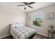 Bedroom features a ceiling fan, wooden floors, and a window view of leafy greenery at 8711 Palmer Park Cir, Sarasota, FL 34238