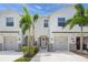 Charming townhomes with well-manicured lawns, decorative stone, and a welcoming front entrance at 8711 Palmer Park Cir, Sarasota, FL 34238