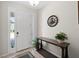 Bright foyer with a console table, decorative clock, and neutral tones at 8711 Palmer Park Cir, Sarasota, FL 34238