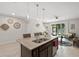 Bright, open kitchen features a granite island, modern pendant lighting and stainless steel appliances at 8711 Palmer Park Cir, Sarasota, FL 34238