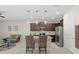 Well-equipped kitchen featuring an island with bar stools, stainless steel appliances, and modern pendant lighting at 8711 Palmer Park Cir, Sarasota, FL 34238