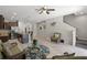 Spacious living area with a modern kitchen, wicker sofas, and a view of the staircase at 8711 Palmer Park Cir, Sarasota, FL 34238