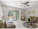 Comfortable living room with sliding glass doors offering a view of the backyard and comfortable wicker furniture at 8711 Palmer Park Cir, Sarasota, FL 34238