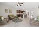 Open-concept living space featuring a modern kitchen, comfortable wicker seating, and bright, neutral décor at 8711 Palmer Park Cir, Sarasota, FL 34238
