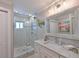 Beautiful bathroom features a glass shower and granite vanity with modern fixtures and a decorative mirror at 10016 Spoonbill E Rd, Bradenton, FL 34209