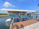 Boat lift with a boat on the canal at 10016 Spoonbill E Rd, Bradenton, FL 34209