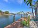 Relaxing waterfront dock with colorful chairs on the canal at 10016 Spoonbill E Rd, Bradenton, FL 34209