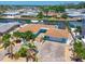 Stunning waterfront home with lush landscaping, a paver driveway, and a serene canal view at 10016 Spoonbill E Rd, Bradenton, FL 34209