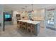 Eat-in kitchen with an island, stainless appliances and views into the living room at 10016 Spoonbill E Rd, Bradenton, FL 34209