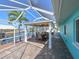 Inviting screened patio features a dining area overlooking the canal at 10016 Spoonbill E Rd, Bradenton, FL 34209
